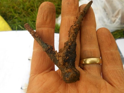 Copper alloy shield corner, two of which were found in close proximity. This would have created a metal rim around a "hide-shaped" shield, a aprticualr pattern of shield only known in Iron Age Britain.